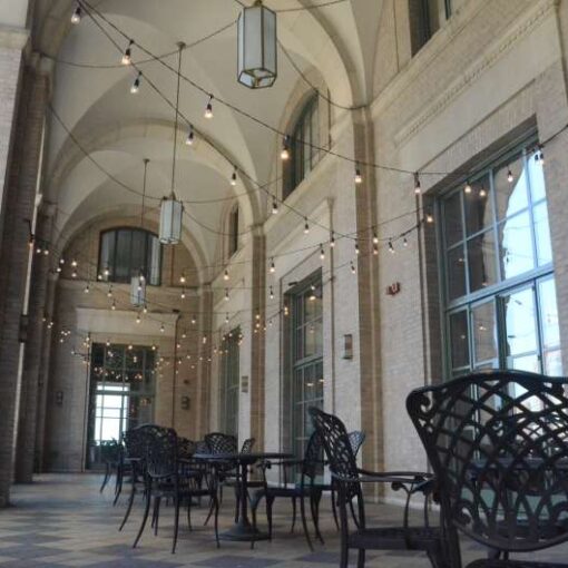 String Lights hanging in a Zigzagging Pattern outdoors above the  9th-floor terrace of The New York Athletic Club.