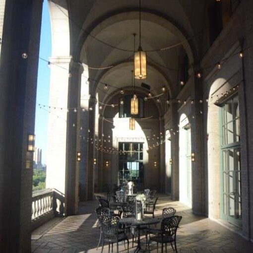 String Lights with round G50 Bulbs hanging above the outdoor balcony for a wedding on the 9th Floor of the New York Athletic Club.