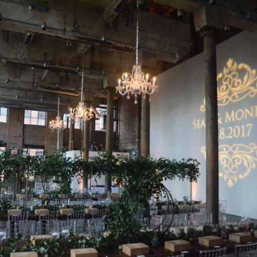 Three Chandeliers hanging at The Smack Mellon Gallery along with a custom gobo and Up-Lights along the perimeter walls.