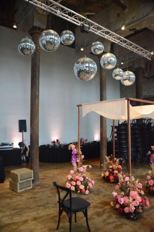 Multiple Mirror Balls hanging above the main floor at The Smack Mellon Gallery along with Up-Lights along the perimeter walls.