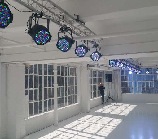 PAR 64 LED lights hanging overhead from Mini-triangular trusses for a fashion show at Studio 450 in New York City.