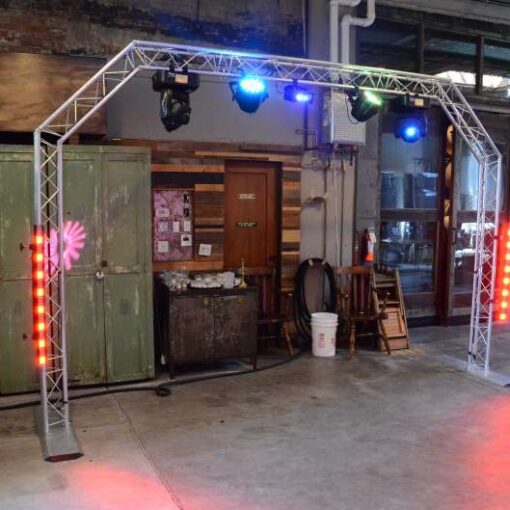 An arched DJ truss featuring intelligent lighting effects and vibrant LED lights to illuminate the dance floor at The Brooklyn Winery.