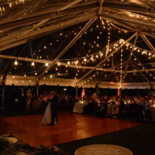 String Lights hanging in a circular pattern under a clear top tent for a wedding at the Morris–Jumel Mansion.