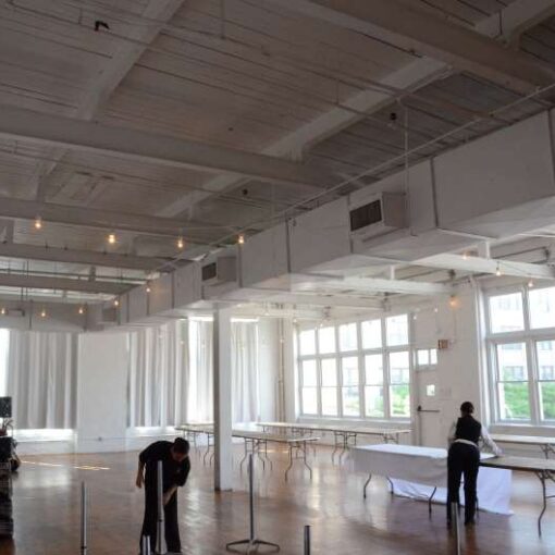 Bistro Lights, also known as Cafe Lights or String Lights, are hanging overhead for a wedding reception in Studio A at The Attic Studios.