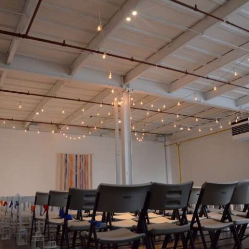 String Lighting (Cafe Lights/ Bistro Lights) hanging overhead for a wedding ceremony in Studio C and reception in Studio A at The Attic Studios.