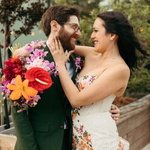 A joyful photo of Sua & Adam near the Norman St. Garden outside Rule of Thirds.