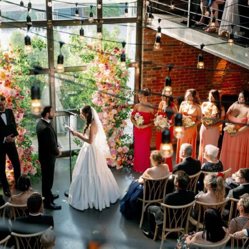 Gianna + Steven's wedding ceremony inside the main reception room with String Lights hanging overhead for their summer wedding at The Foundry