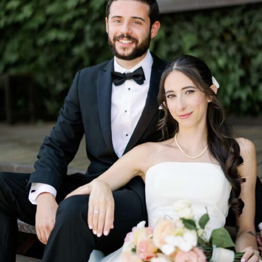 Gianna + Steven sitting on The Porch in the courtyard for their summer wedding at The Foundry
