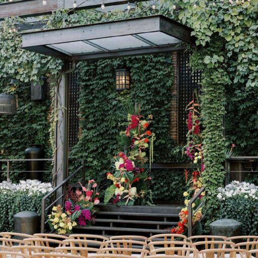 Ceremony chairs in the courtyard for Tina & Real's outdoor NYC wedding reception at The Foundry with String Lights hanging overhead.