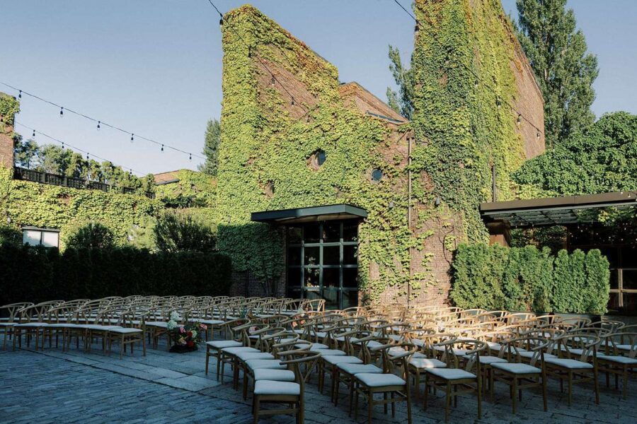 Ceremony chairs in the courtyard for Tina & Real's outdoor NYC wedding reception at The Foundry with String Lights hanging overhead.