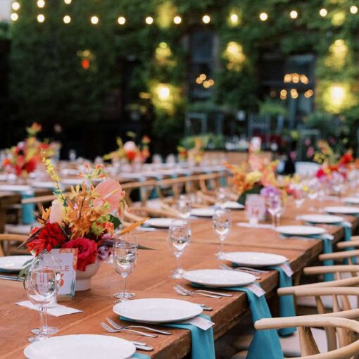 Dinner tables in the courtyard for Tina & Real's outdoor NYC wedding reception at The Foundry.