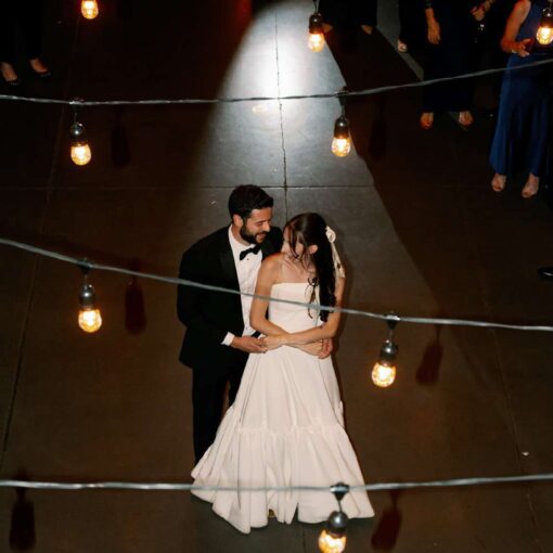 String Lights hanging overhead inside the main reception room for Gianna + Steven's first dance at there wedding in The Foundry