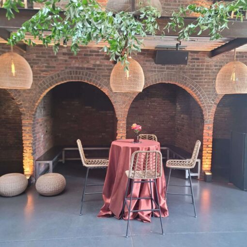 Hanging rattan lanterns and Up-lights, paired with earthy hues and bold tropical florals, helped create a relaxed African-infused wedding at The Foundry.