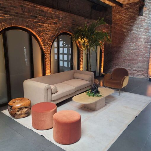 Up-Lights, paired with earthy hues and bold tropical florals, helped create a relaxed lounge setting at an African-infused wedding at The Foundry.