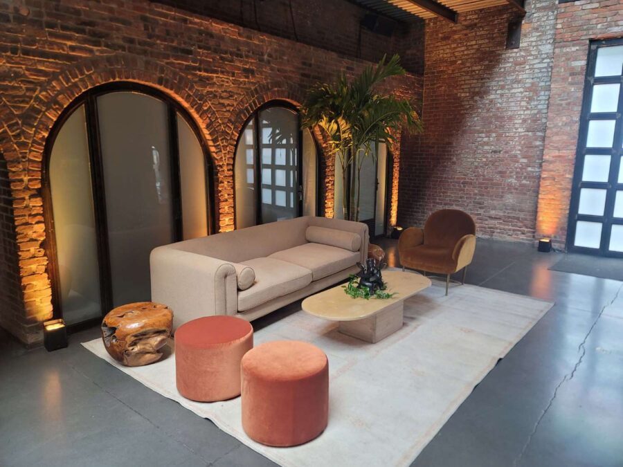 Up-Lights, paired with earthy hues and bold tropical florals, helped create a relaxed lounge setting at an African-infused wedding at The Foundry.