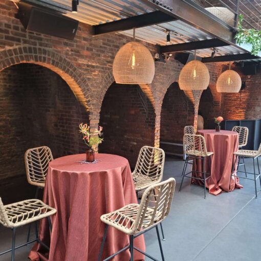 Hanging rattan lanterns, paired with earthy hues and bold tropical florals, helped create a relaxed African-infused wedding at The Foundry.