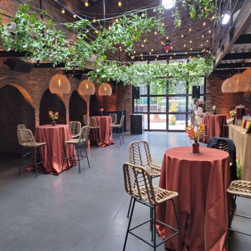 Hanging rattan lanterns, String Lights, and Up-Lights, paired with earthy hues and bold tropical florals, helped create a relaxed African-infused wedding at The Foundry.