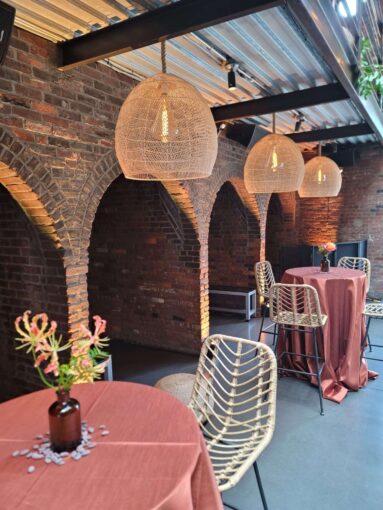 Hanging rattan lanterns, paired with earthy hues and bold tropical florals, helped create a relaxed African-infused wedding at The Foundry.