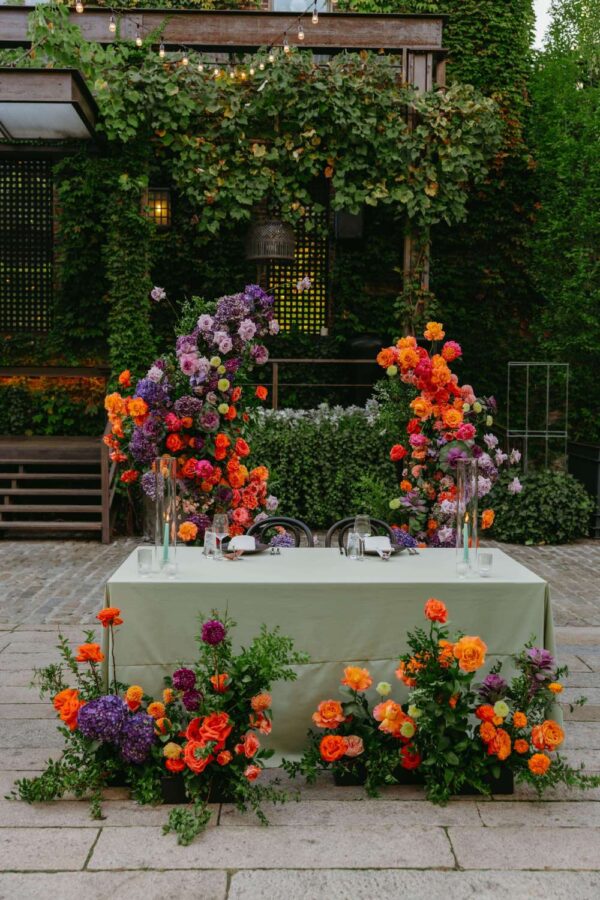 String lights above the head table at an outdoor NYC wedding