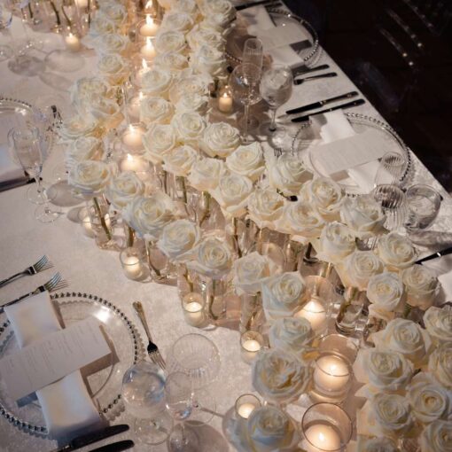 The florals at the head table and the table setting at Taylor and Troy's elegant wedding at The Lighthouse at Chelsea Piers. The florals at the head table and the table setting at Taylor and Troy's elegant wedding at The Lighthouse at Chelsea Piers.