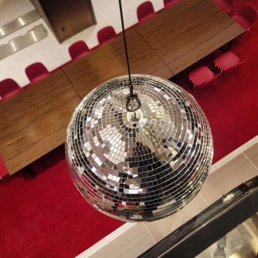 A rotating Mirror Ball hang from the ceiling for a wedding in The Constellation Ballroom at The TWA Hotel.