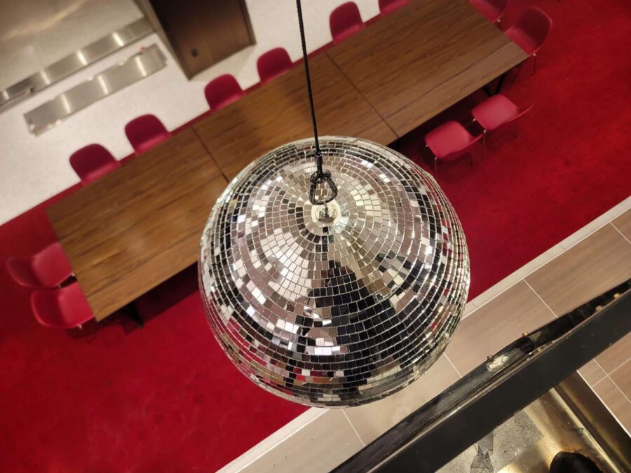 A rotating Mirror Ball hang from the ceiling for a wedding in The Constellation Ballroom at The TWA Hotel.
