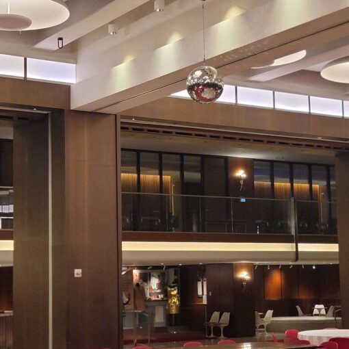 A rotating Mirror Ball hang from the ceiling for a wedding in The Constellation Ballroom at The TWA Hotel.