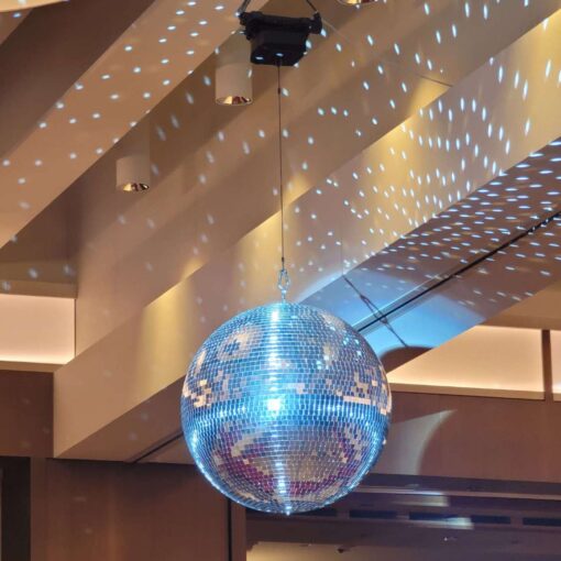 A rotating Mirror Ball hang from the ceiling for a wedding in The Constellation Ballroom at The TWA Hotel.
