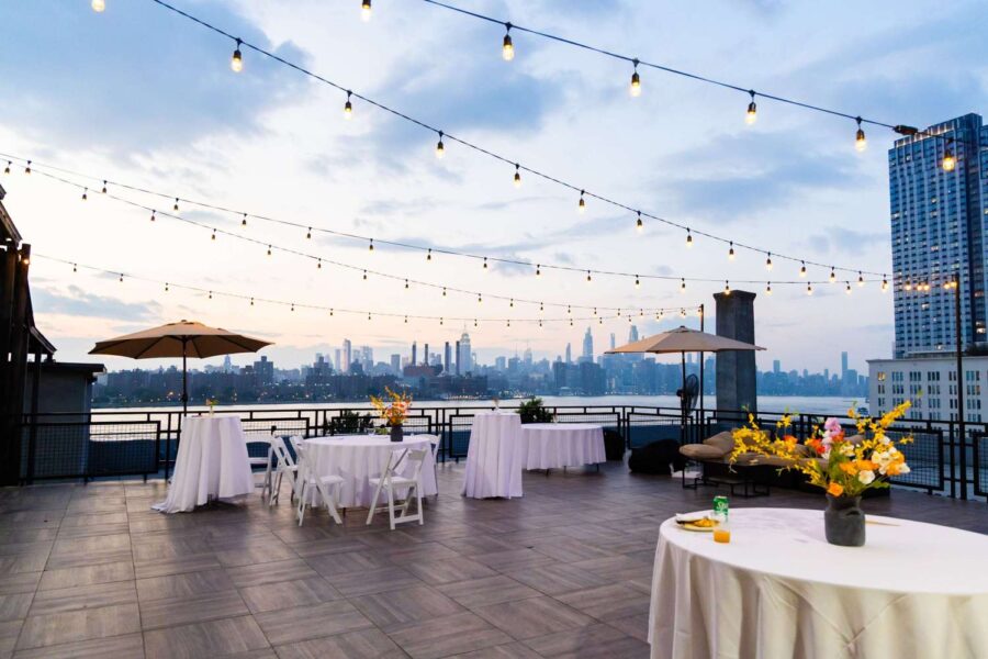 String Lights above the rooftop terrace at The W-Loft, alongside panoramic views of the Manhattan skyline, are a perfect backdrop for a NYC wedding.