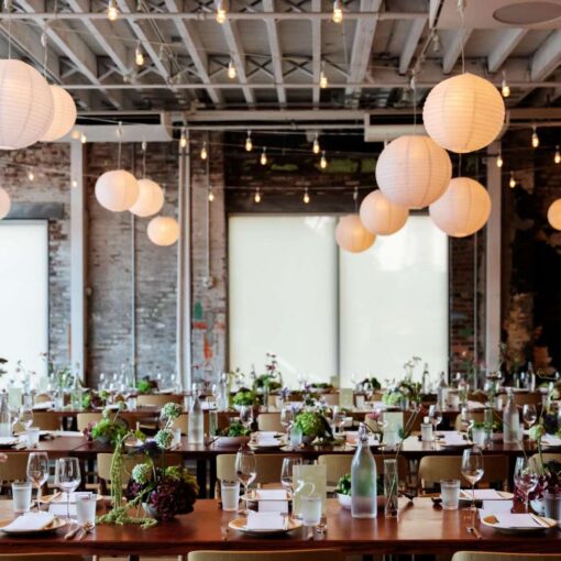 Zigzag string lights with paper lanterns hanging in The Corner Room for Julia + Ray's wedding reception at Rule of Thirds in Brooklyn, NY. Zigzag string lights with paper lanterns hanging in The Corner Room for Julia + Ray's wedding reception at Rule of Thirds in Brooklyn, NY.