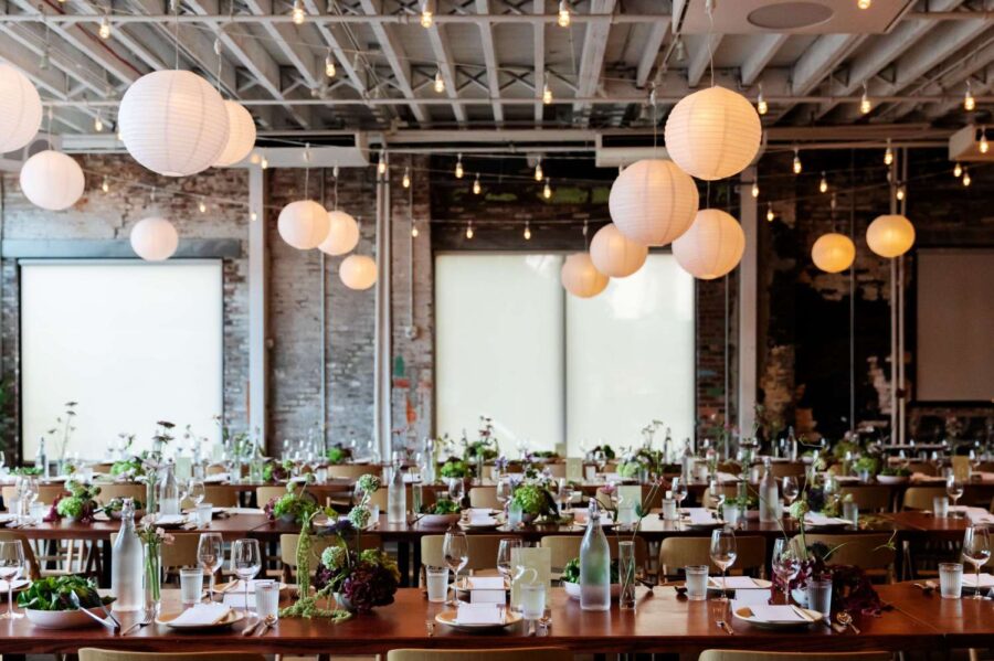 Zigzag string lights with paper lanterns hanging in The Corner Room for Julia + Ray's wedding reception at Rule of Thirds in Brooklyn, NY.