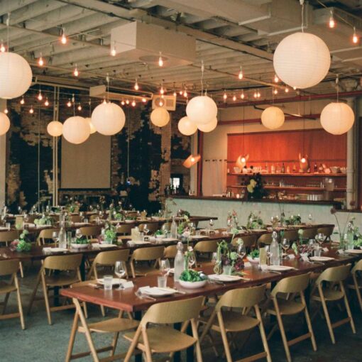 Zigzag string lights with paper lanterns hanging in The Corner Room for Julia + Ray's wedding reception at Rule of Thirds in Brooklyn, NY. Zigzag string lights with paper lanterns hanging in The Corner Room for Julia + Ray's wedding reception at Rule of Thirds in Brooklyn, NY.