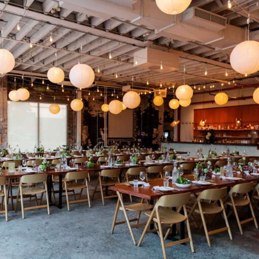 Zigzag string lights with paper lanterns hanging in The Corner Room for Julia + Ray's wedding reception at Rule of Thirds in Brooklyn, NY. Zigzag string lights with paper lanterns hanging in The Corner Room for Julia + Ray's wedding reception at Rule of Thirds in Brooklyn, NY.