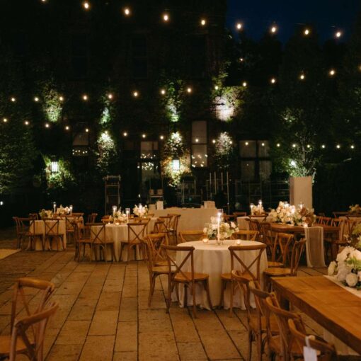 Dining outdoors in The Courtyard under String Lights at Kasey and Andrew's wedding at The Foundry - September 13, 2024