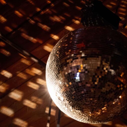A rotting Mirror Ball above the dance floor at Christie and Drew's wedding at The Wythe Hotel.
