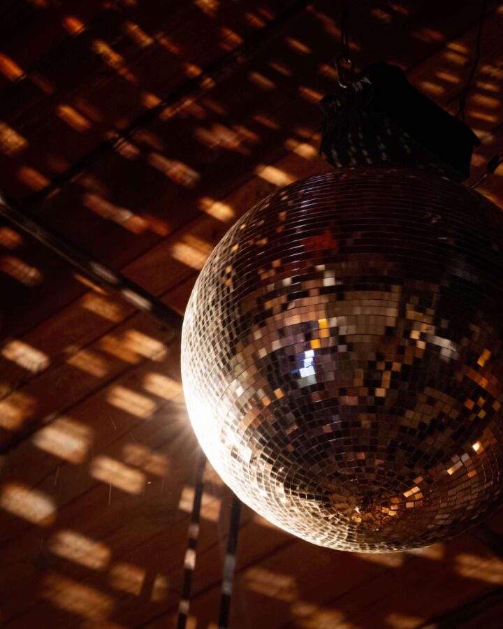 A rotting Mirror Ball above the dance floor at Christie and Drew's wedding at The Wythe Hotel.