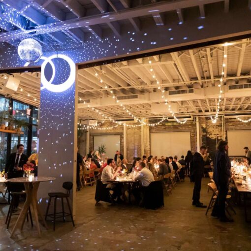 A rotating mirror ball in The Atrium and parallel string lights in The Corner Room at Arden and Keith’s vibrant and colorful Brooklyn wedding at Rule of Thirds.