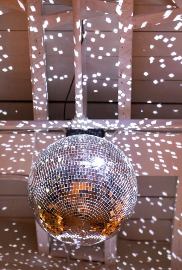A rotating mirror ball in The Atrium at Arden and Keith vibrant and colorful Brooklyn wedding at Rule of Thirds.