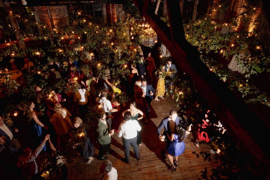 String Lighting hanging in a circular pattern with greenery at The Greenpoint Loft.