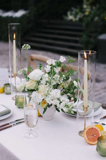 Glass hurricane Candle Shades for a table setting at a Wedding.