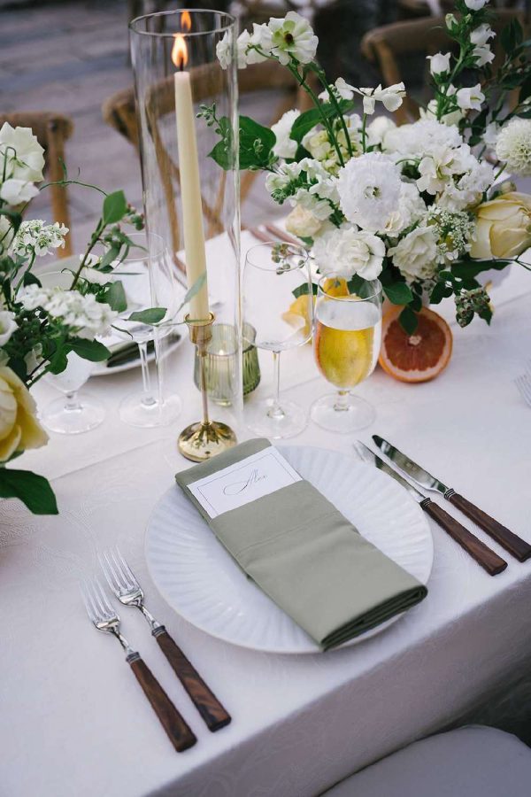 Glass hurricane Candle Shades for a table setting at a Wedding.