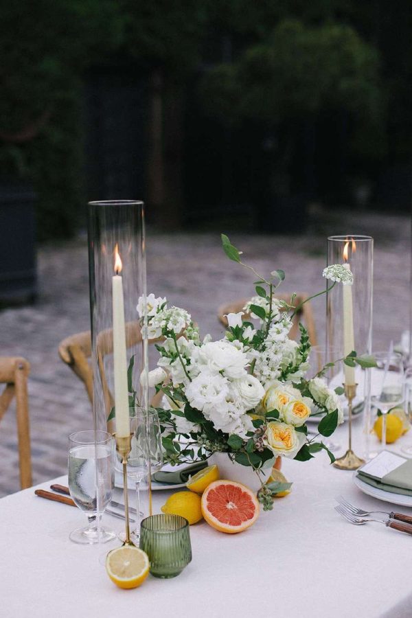 Glass hurricane Candle Shades for a table setting at a Wedding.