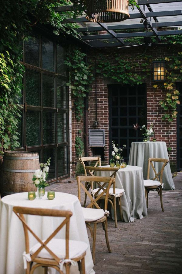Outdoor Cocktail Tables with wooden chairs and green Candles