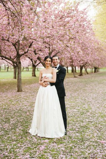 Christina and Cory's spring wedding photo under the iconic cherry blossoms at The Brooklyn Botanic Garden.