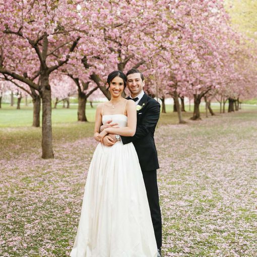 Christina and Cory's spring wedding photo under the iconic cherry blossoms at The Brooklyn Botanic Garden. Christina and Cory's spring wedding photo under the iconic cherry blossoms at The Brooklyn Botanic Garden.