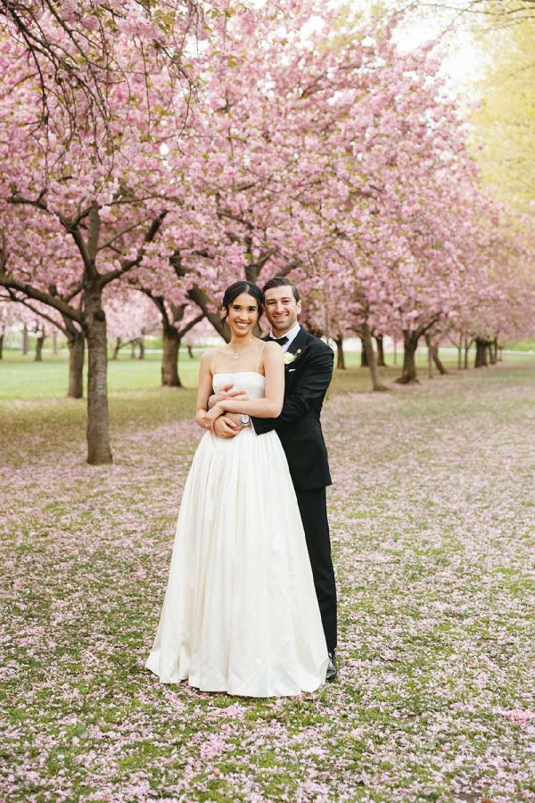 Christina and Cory's spring wedding photo under the iconic cherry blossoms at The Brooklyn Botanic Garden.