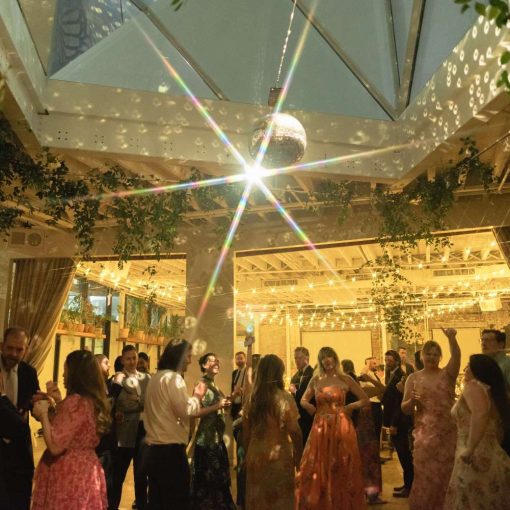 A rotating Mirror Ball hanging in The Atrium above the dance floor and String Lights hanging in The Corner Room at Rule of Thirds in Brooklyn, NY.