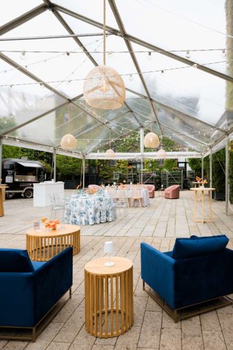 Ace Party Rental set up a clear top tent in the Courtyard at The Foundry for their April Open House. Additionally, Broadway Party Rentals supplied the furniture. Finally, Universal Light and Sound provided the string lights and rattan lanterns.