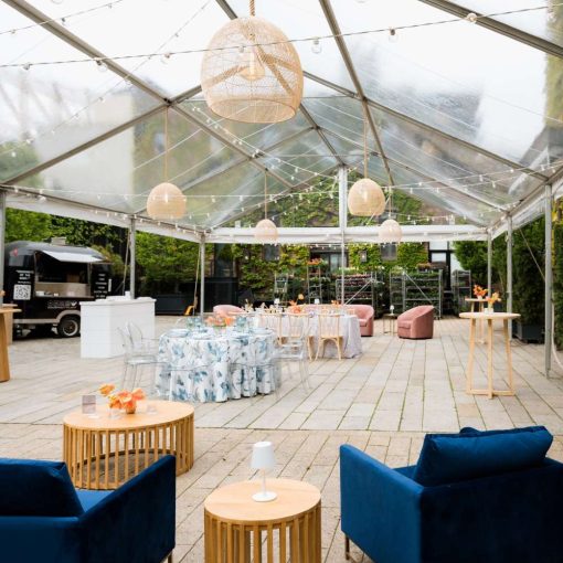 Ace Party Rental set up a clear top tent in the Courtyard at The Foundry for their April Open House. Additionally, Broadway Party Rentals supplied the furniture. Finally, Universal Light and Sound provided the string lights and rattan lanterns.