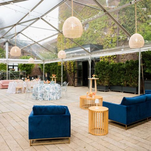 Ace Party Rental set up a clear top tent in the Courtyard at The Foundry for their April Open House. Additionally, Broadway Party Rentals supplied the furniture. Finally, Universal Light and Sound provided the string lights and rattan lanterns.